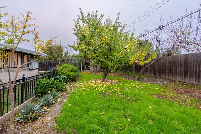 a backyard of a house with table and chairs