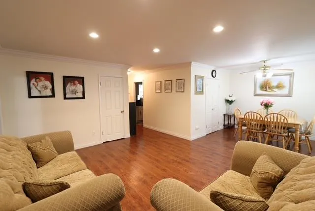 a living room with furniture and a wooden floor