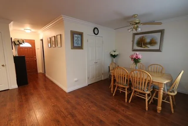 a dining room with furniture and wooden floor