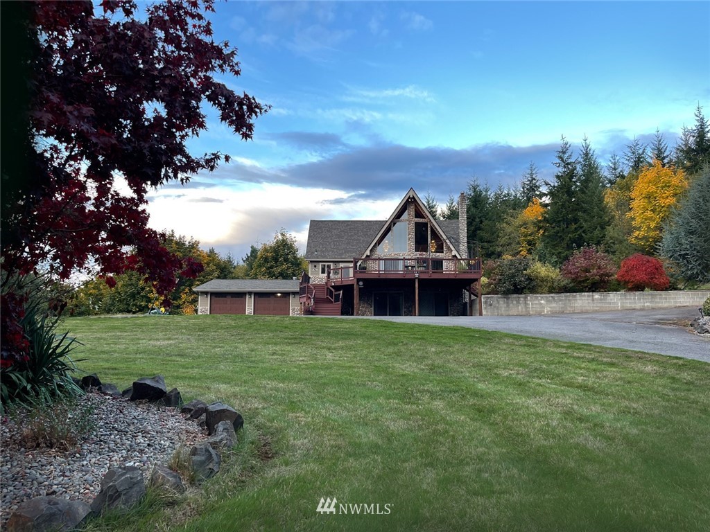 779 Cousins Road Chehalis, WA 98532 - Photo 3 of 39 a view of a big house with a big yard and potted plants in front of it