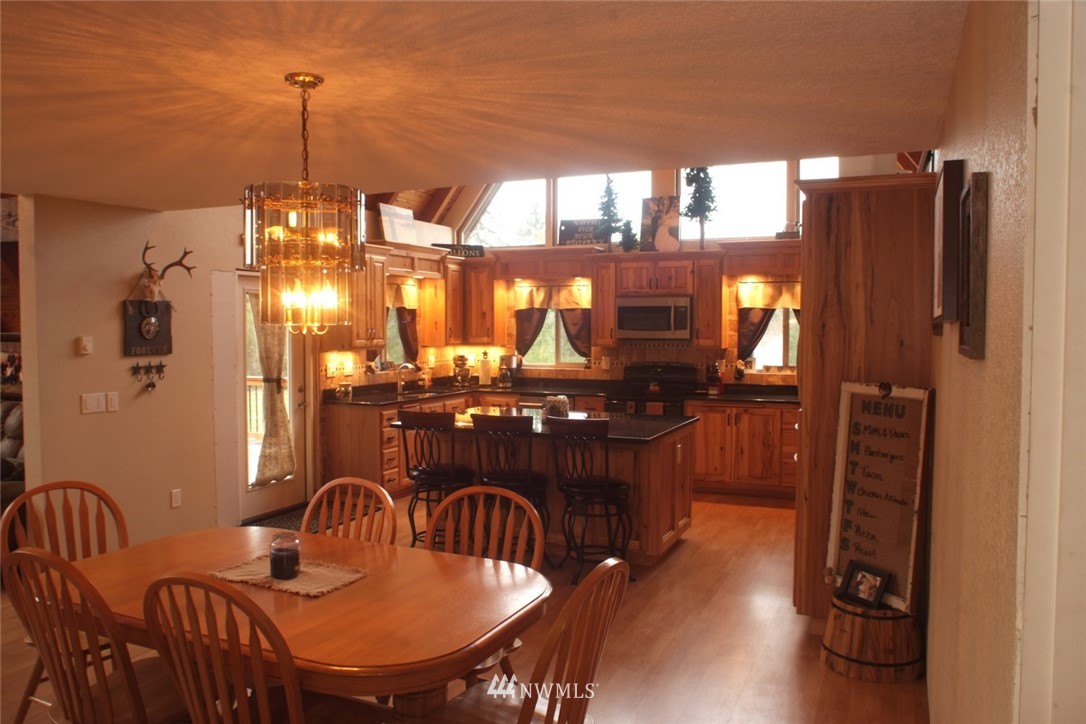 779 Cousins Road Chehalis, WA 98532 - Photo 22 of 39 a dining room with furniture a chandelier and wooden floor