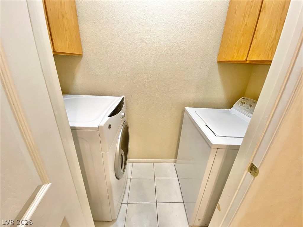 10550 West Alexander Road, Unit 1131 Las Vegas, NV 89129 - Photo 7 of 18 Functional laundry nook includes both a washer and dryer with convenient overhead cabinetry.