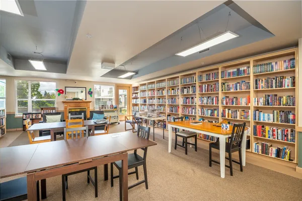 a room with lots of furniture and a book shelf