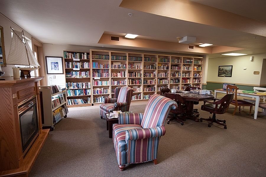 11939 Northeast Davis Street Portland, OR 97220 - Photo 14 of 14 a living room with furniture a bookshelf and a book shelf