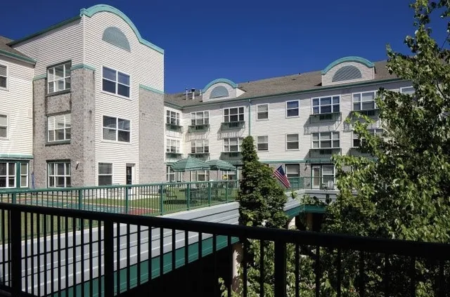 a front view of a building with a garden