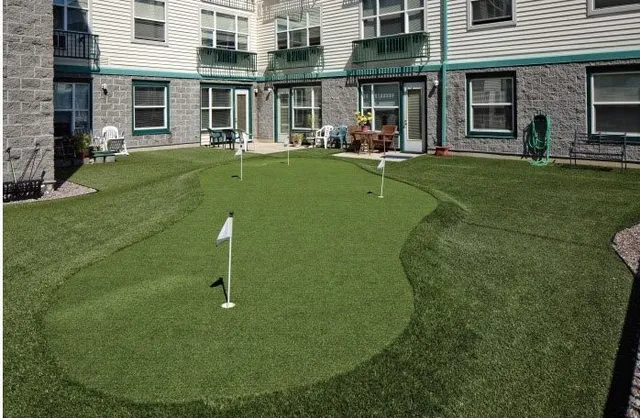 front view of a brick building with a yard