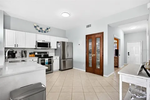a kitchen with stainless steel appliances a refrigerator and a stove top oven