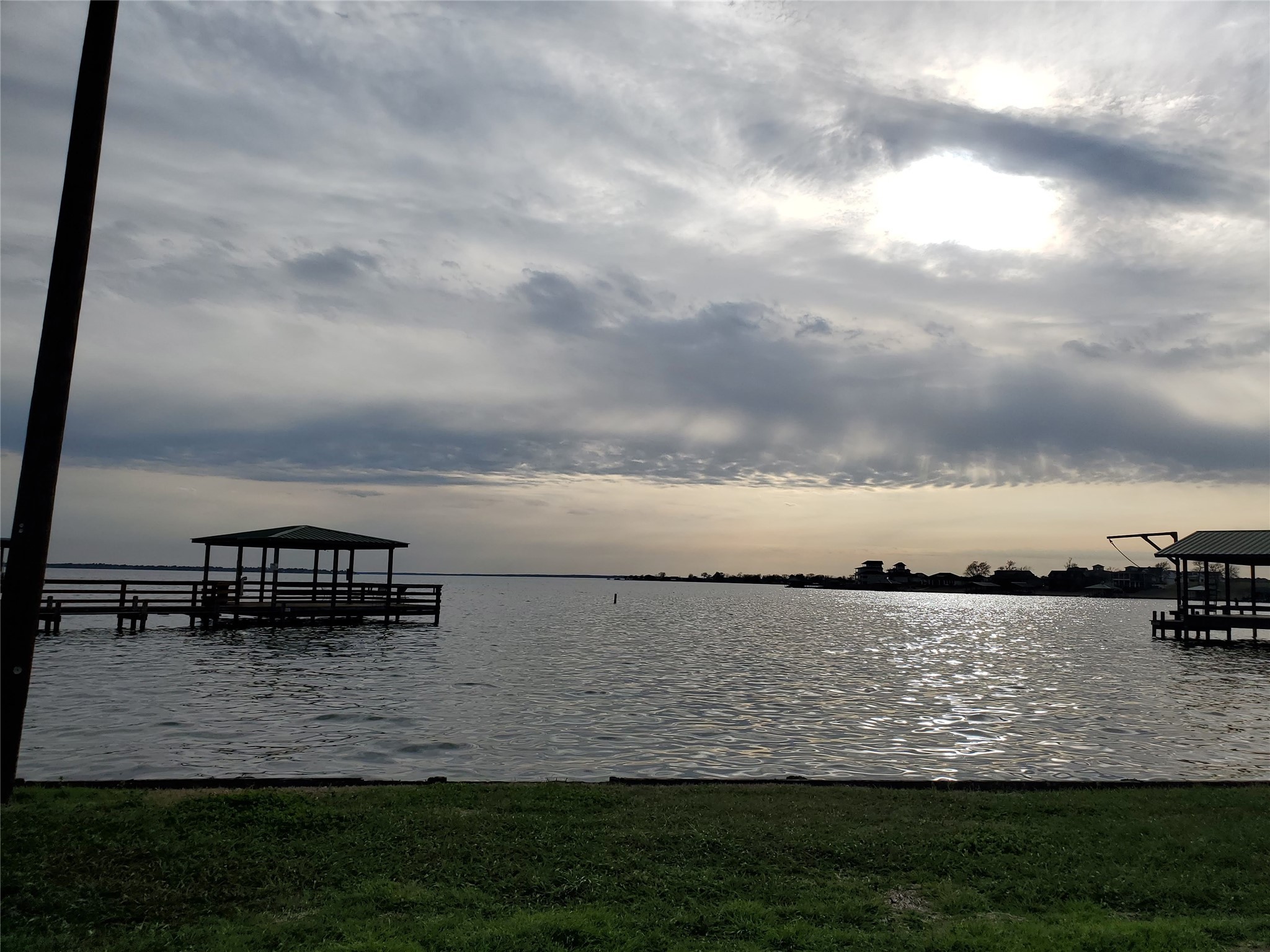 Tbd Acorn Livingston, TX 77351 - Photo 6 of 6 a view of a lake with lawn chairs and large trees