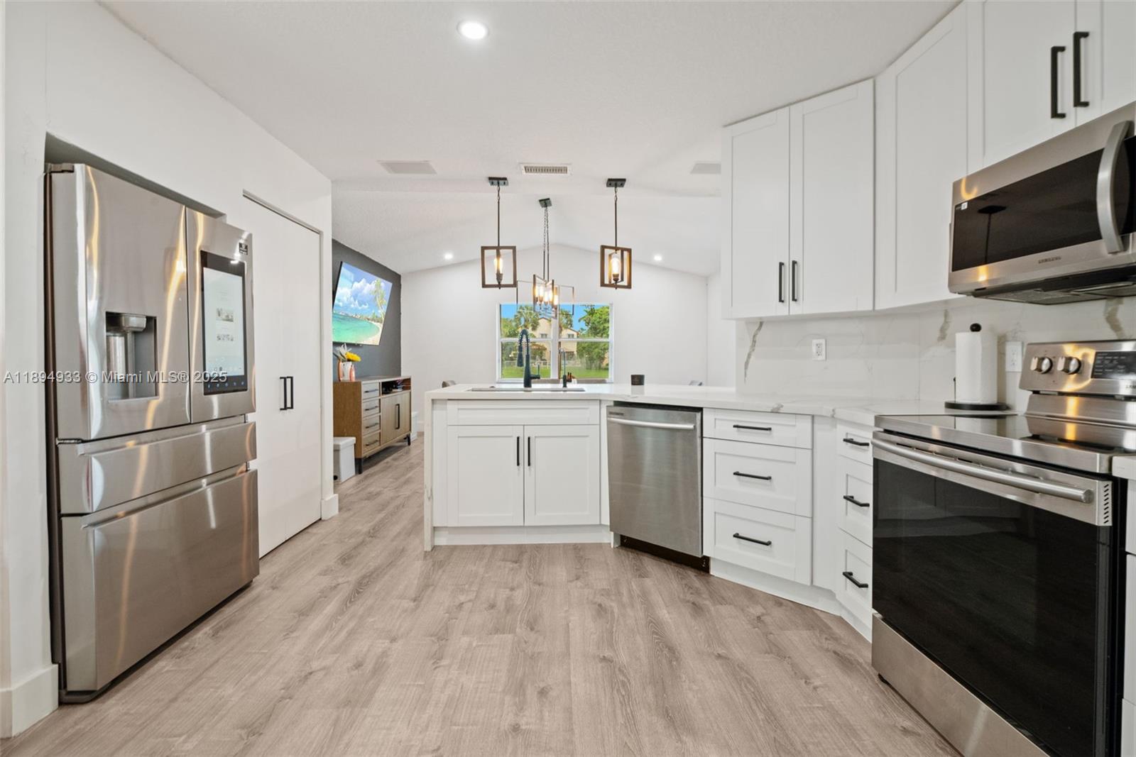 1611 Southwest 158th Avenue Pembroke Pines, FL 33027 - Photo 11 of 25 a kitchen with stainless steel appliances a stove sink and refrigerator