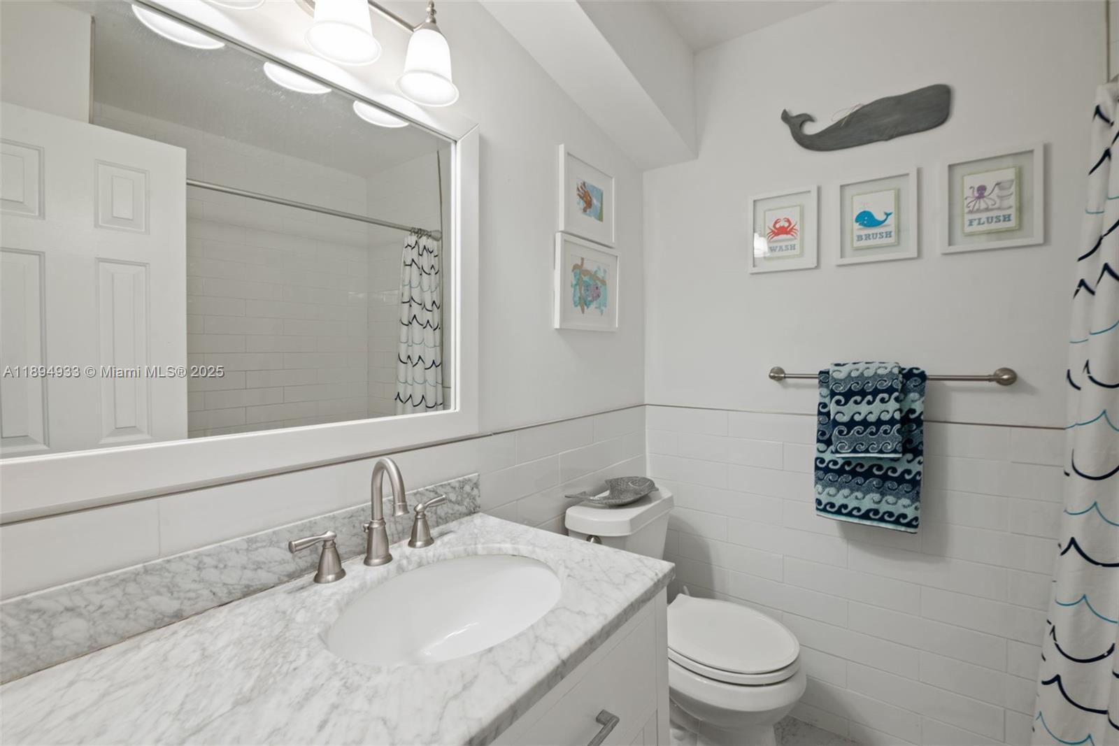 1611 Southwest 158th Avenue Pembroke Pines, FL 33027 - Photo 20 of 25 a bathroom with a toilet a sink and a mirror
