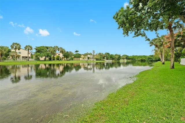 a view of a lake with houses in the back