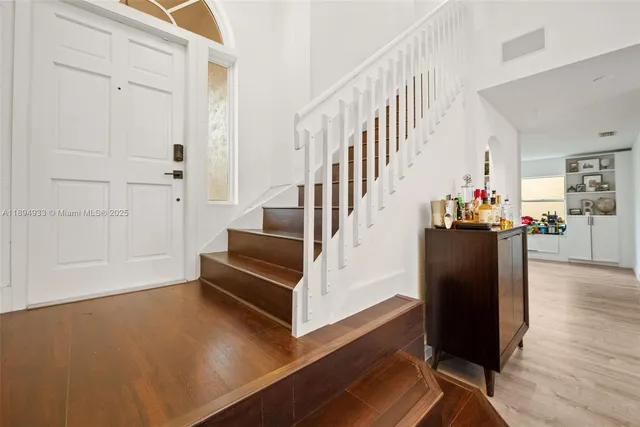 a view of entryway and hall with wooden floor