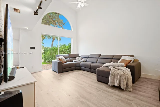 a living room with furniture a fireplace and a chandelier