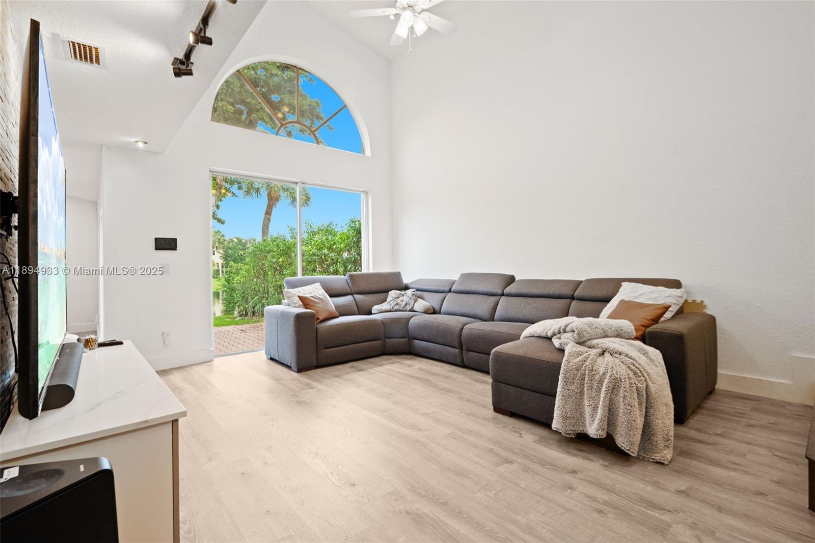 1611 Southwest 158th Avenue Pembroke Pines, FL 33027 - Photo 5 of 25 a living room with furniture a fireplace and a chandelier