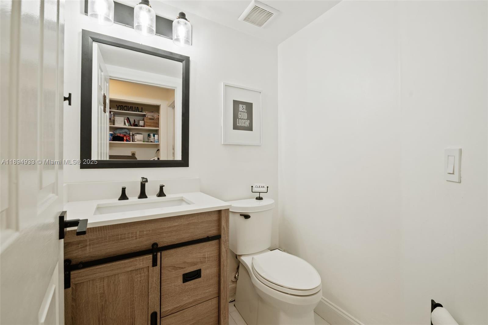 1611 Southwest 158th Avenue Pembroke Pines, FL 33027 - Photo 8 of 25 a bathroom with a toilet sink and mirror