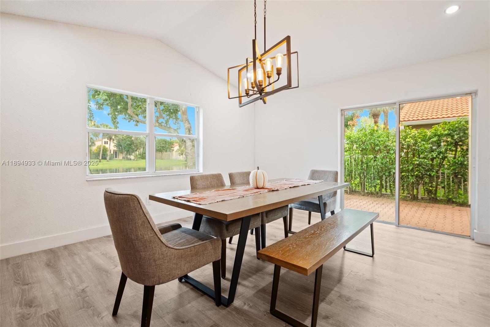 1611 Southwest 158th Avenue Pembroke Pines, FL 33027 - Photo 9 of 25 a view of a dining room with furniture and a potted plant