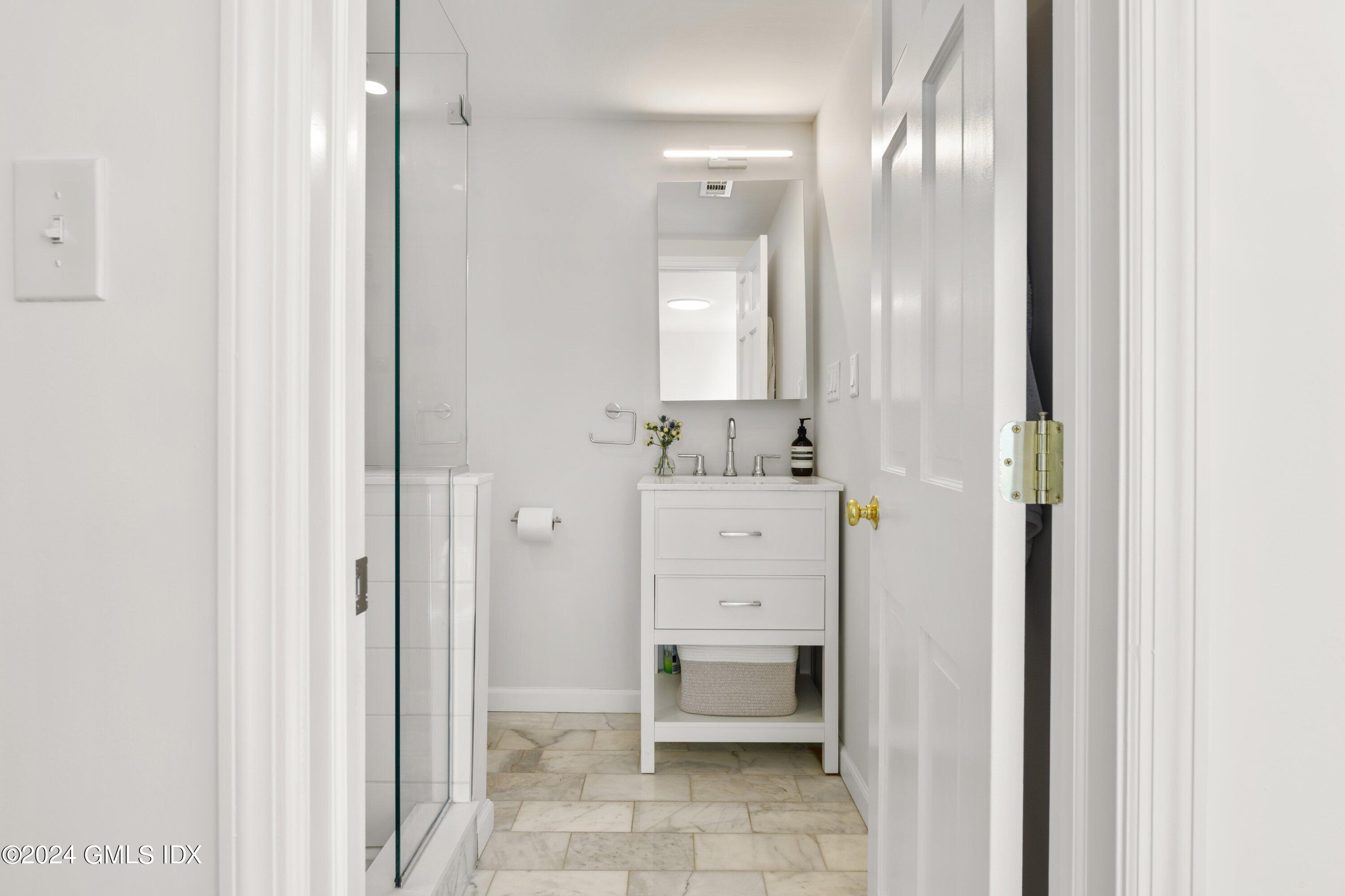 6 Miltiades Avenue Riverside, CT 06878 - Photo 15 of 24 a bathroom with a sink and a mirror