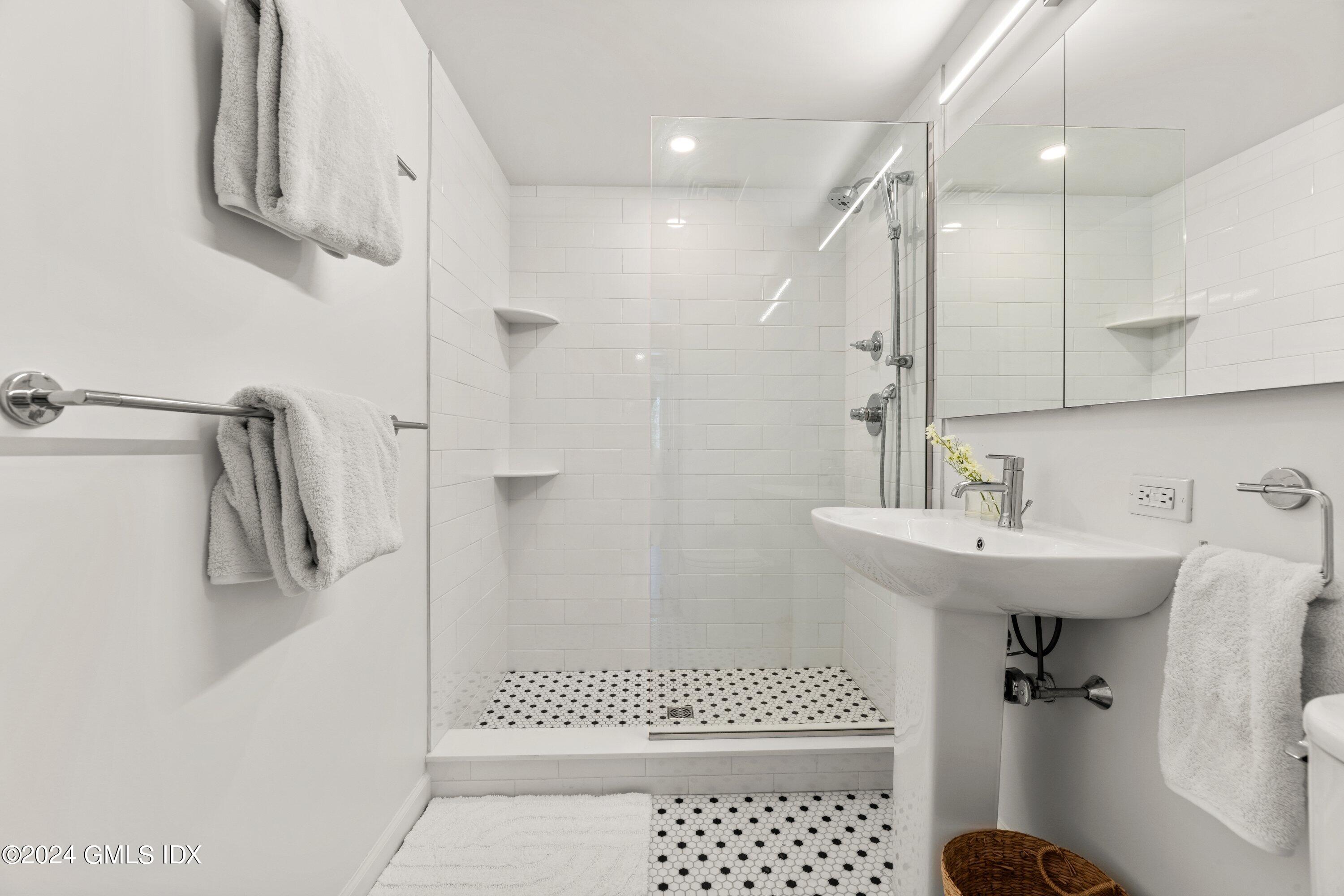 6 Miltiades Avenue Riverside, CT 06878 - Photo 18 of 24 a bathroom with a sink a toilet a mirror and shower