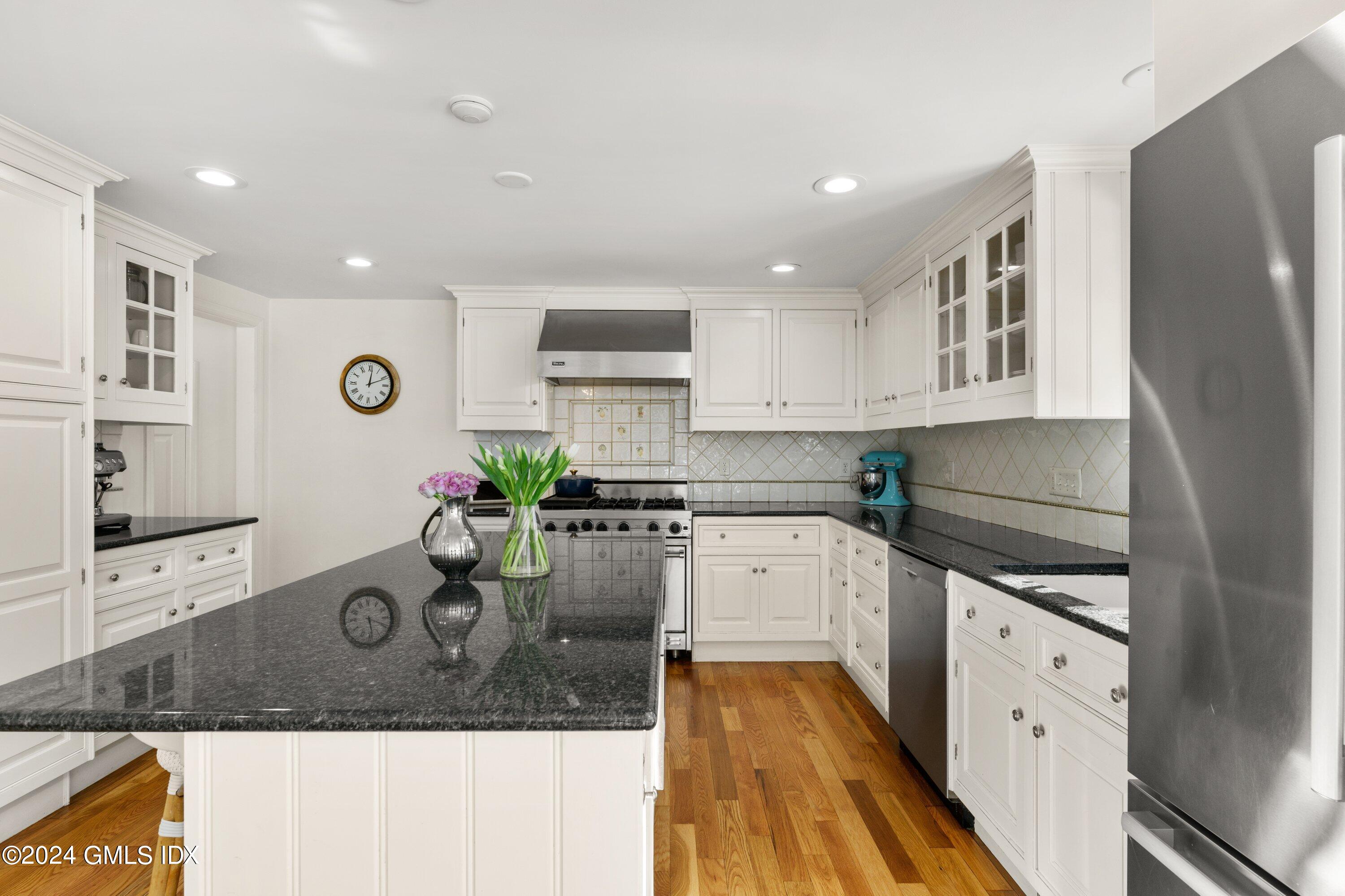 6 Miltiades Avenue Riverside, CT 06878 - Photo 6 of 24 a kitchen with stainless steel appliances granite countertop a refrigerator and a stove top oven
