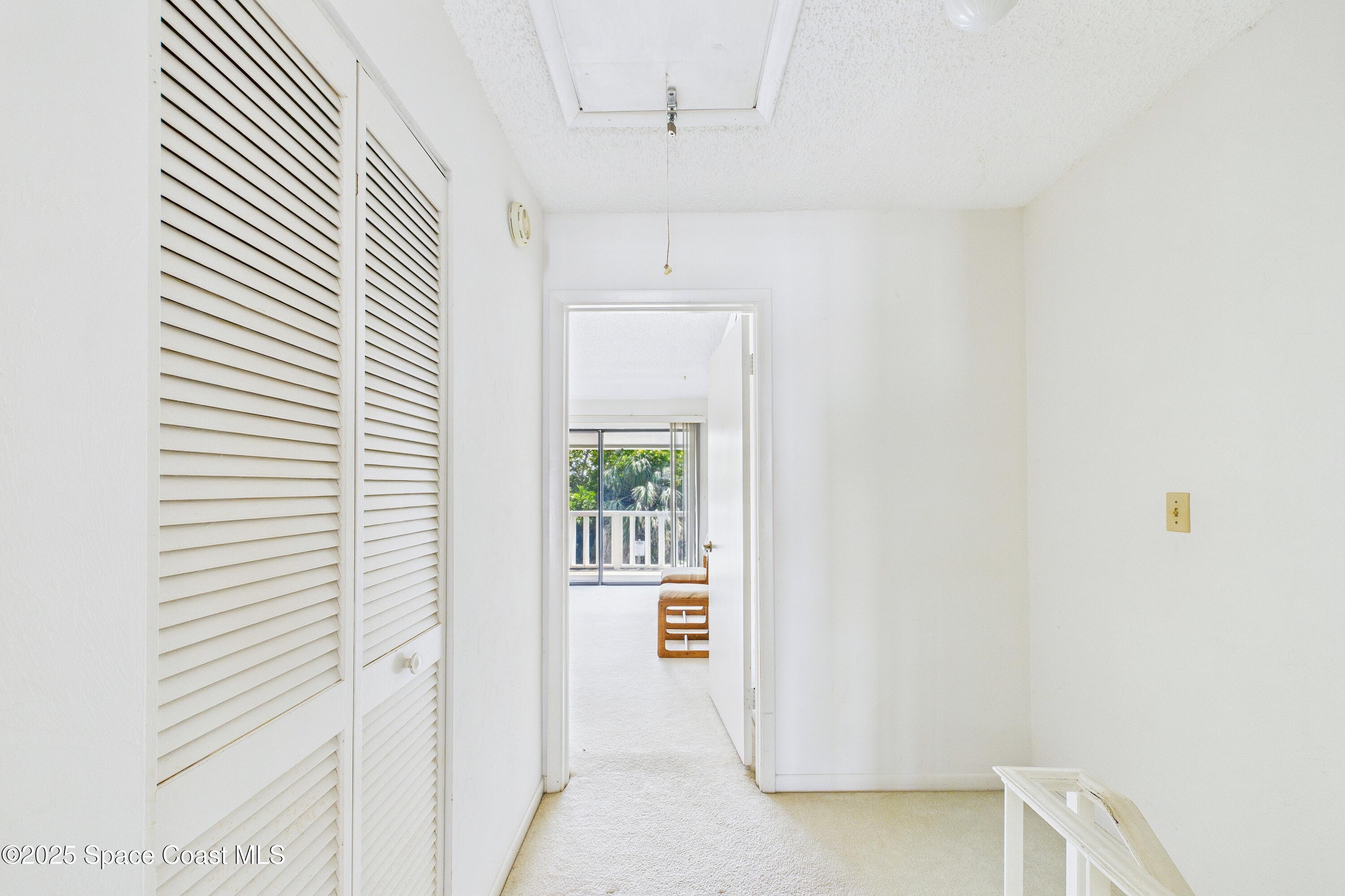 21 Cove Road, Unit 21E Melbourne Beach, FL 32951 - Photo 13 of 30 a view of a hallway with closet