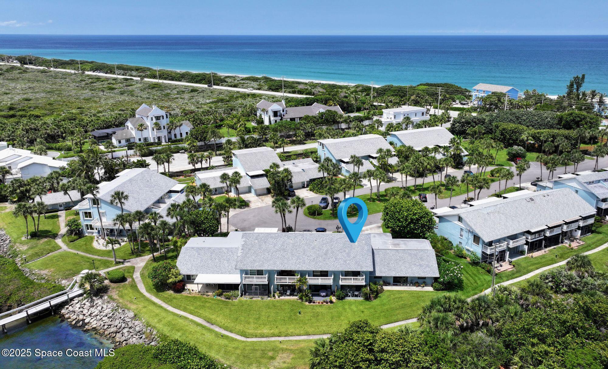 21 Cove Road, Unit 21E Melbourne Beach, FL 32951 - Photo 2 of 30 an aerial view of a house with a garden