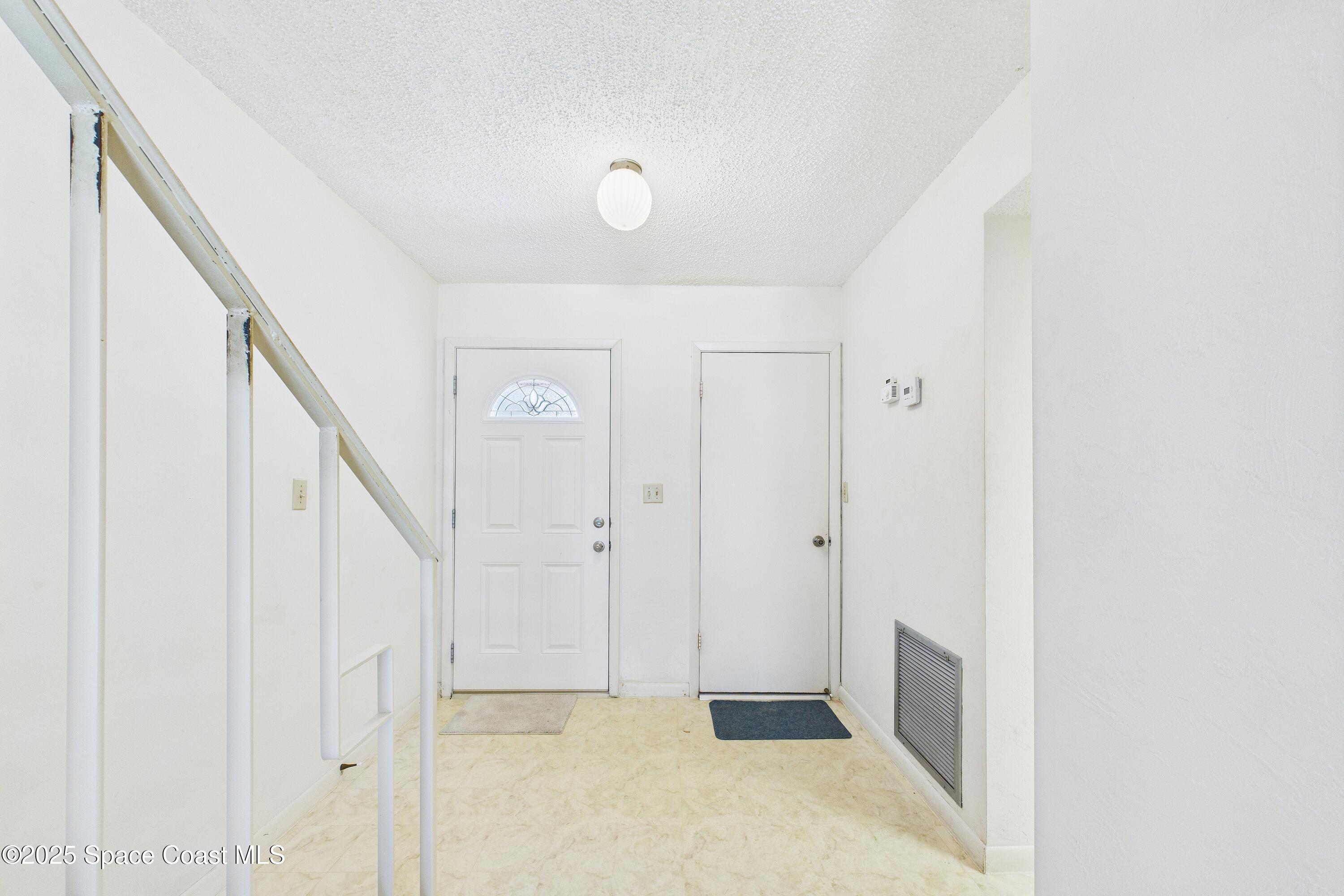 21 Cove Road, Unit 21E Melbourne Beach, FL 32951 - Photo 24 of 30 a view of a hallway with staircase