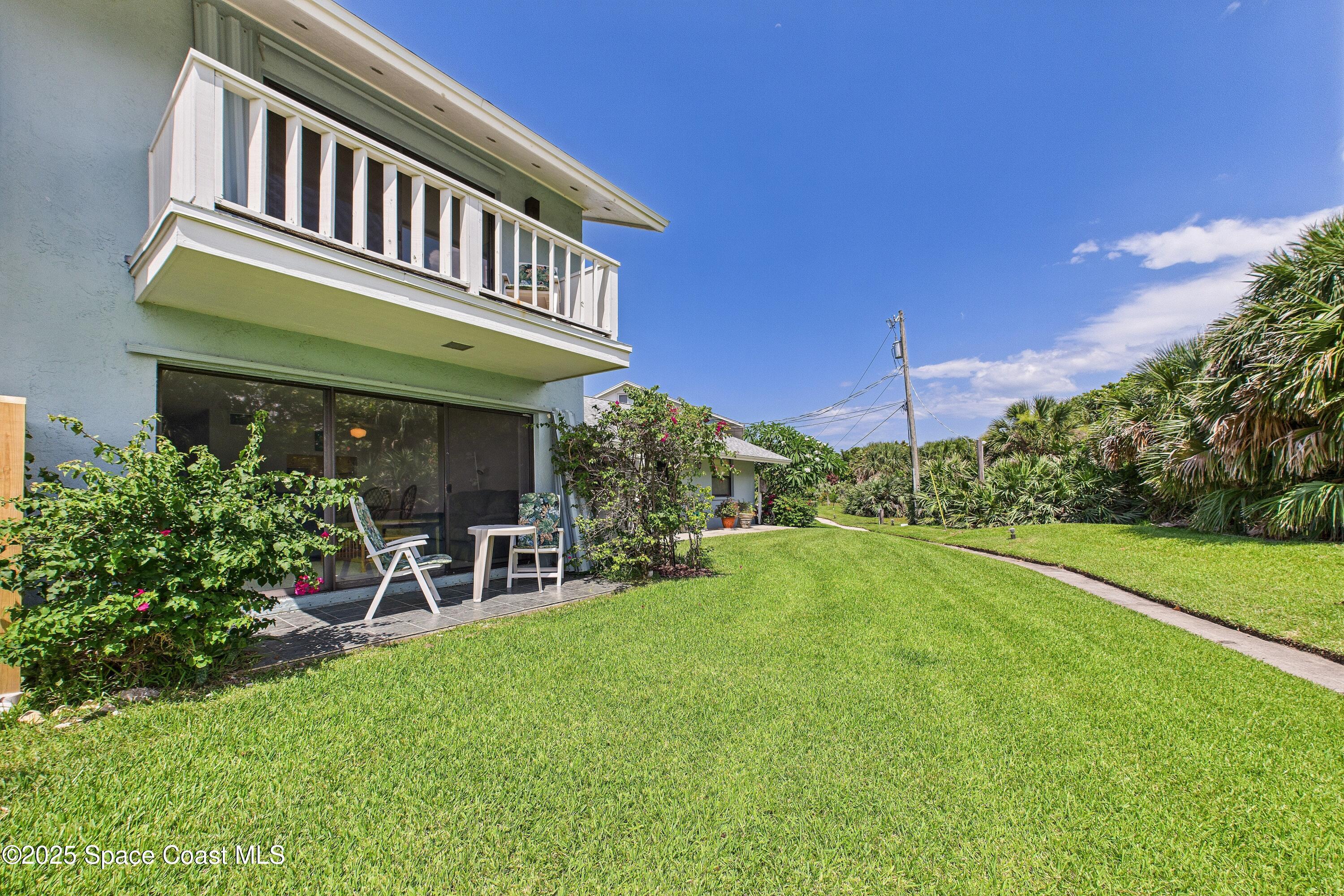 21 Cove Road, Unit 21E Melbourne Beach, FL 32951 - Photo 26 of 30 a view of a house with a yard porch and sitting area