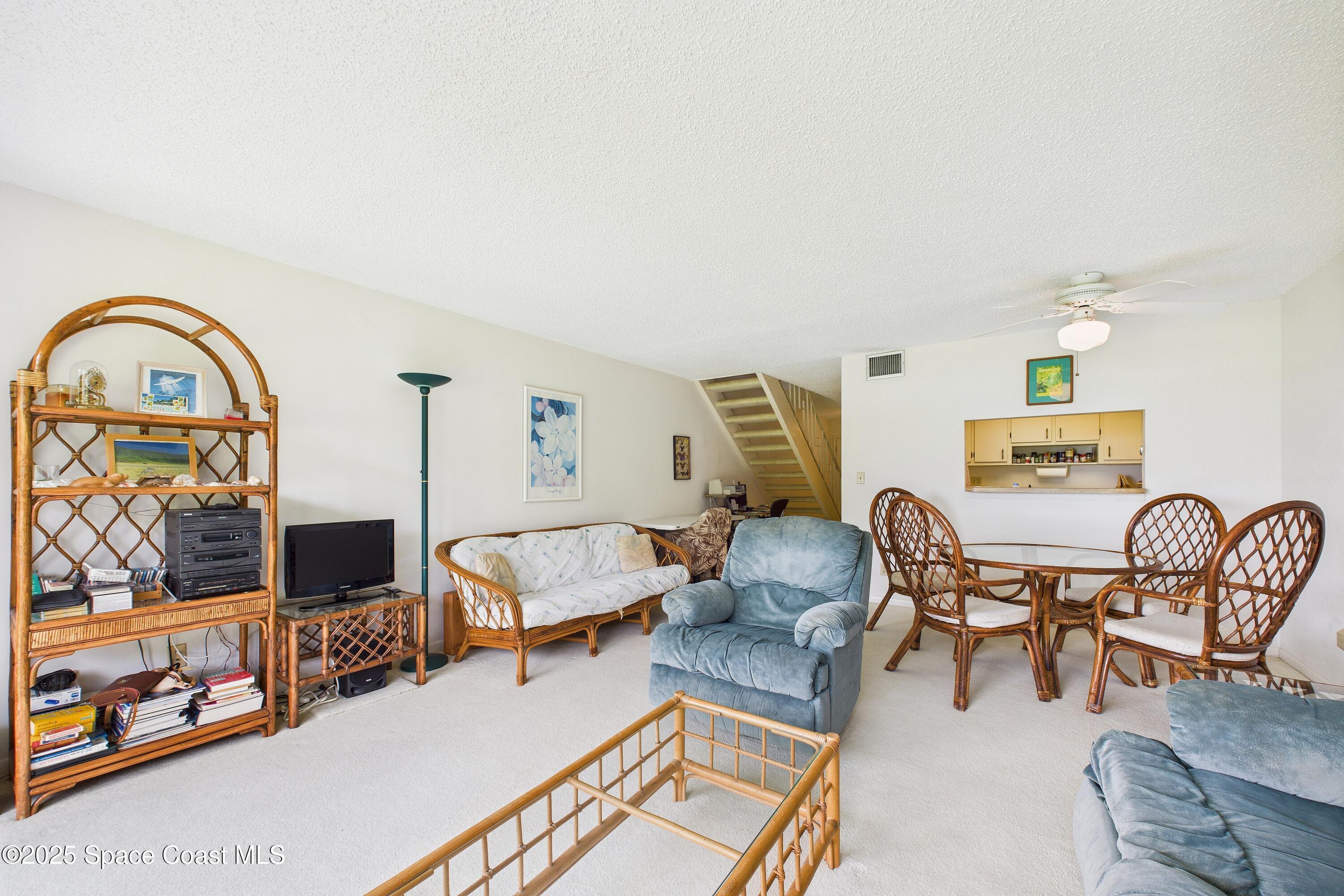 21 Cove Road, Unit 21E Melbourne Beach, FL 32951 - Photo 6 of 30 a living room with furniture and a flat screen tv