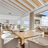 a very nice looking dining room with a large window and kitchen view