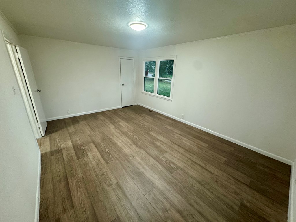 30 McClure Road Epworth, GA 30541 - Photo 12 of 27 an empty room with wooden floor and windows