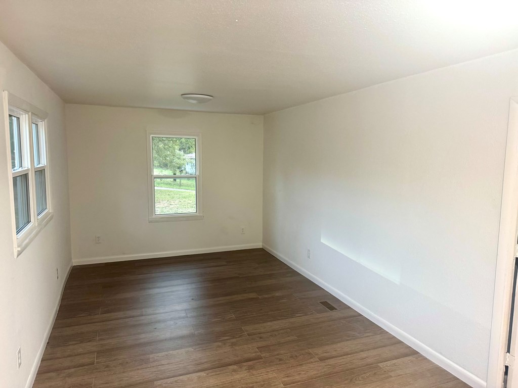30 McClure Road Epworth, GA 30541 - Photo 22 of 27 an empty room with wooden floor and windows