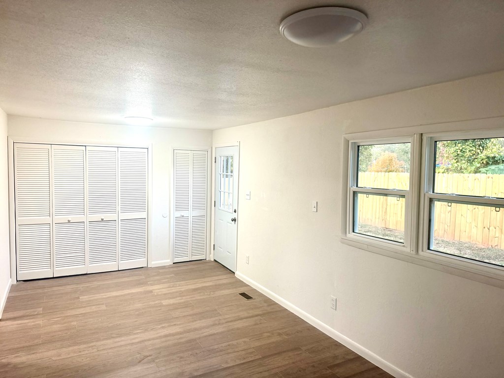 30 McClure Road Epworth, GA 30541 - Photo 23 of 27 an empty room with wooden floor and windows