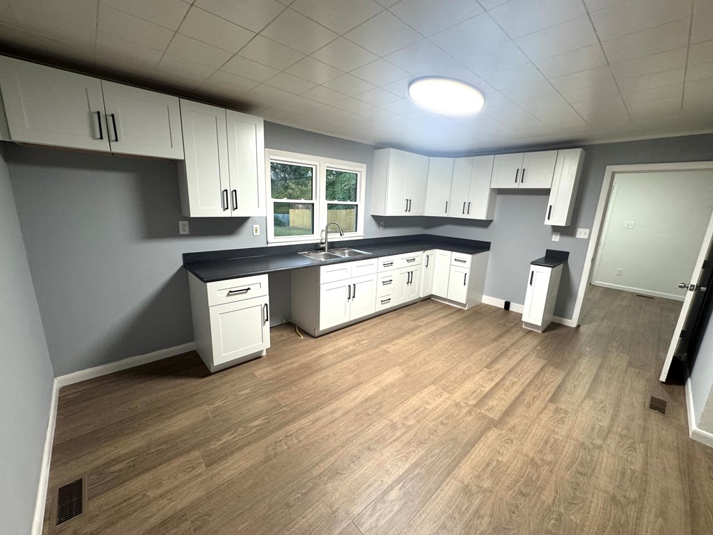 30 McClure Road Epworth, GA 30541 - Photo 27 of 27 a large kitchen with a wooden floor and cabinets