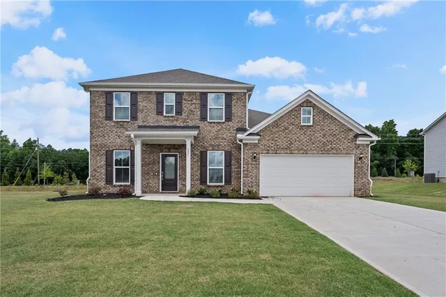 a front view of a house with garden