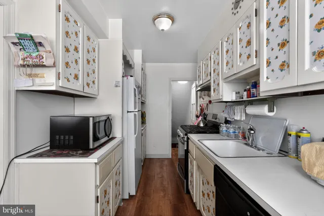 a kitchen with stainless steel appliances a stove a sink a refrigerator and cabinets