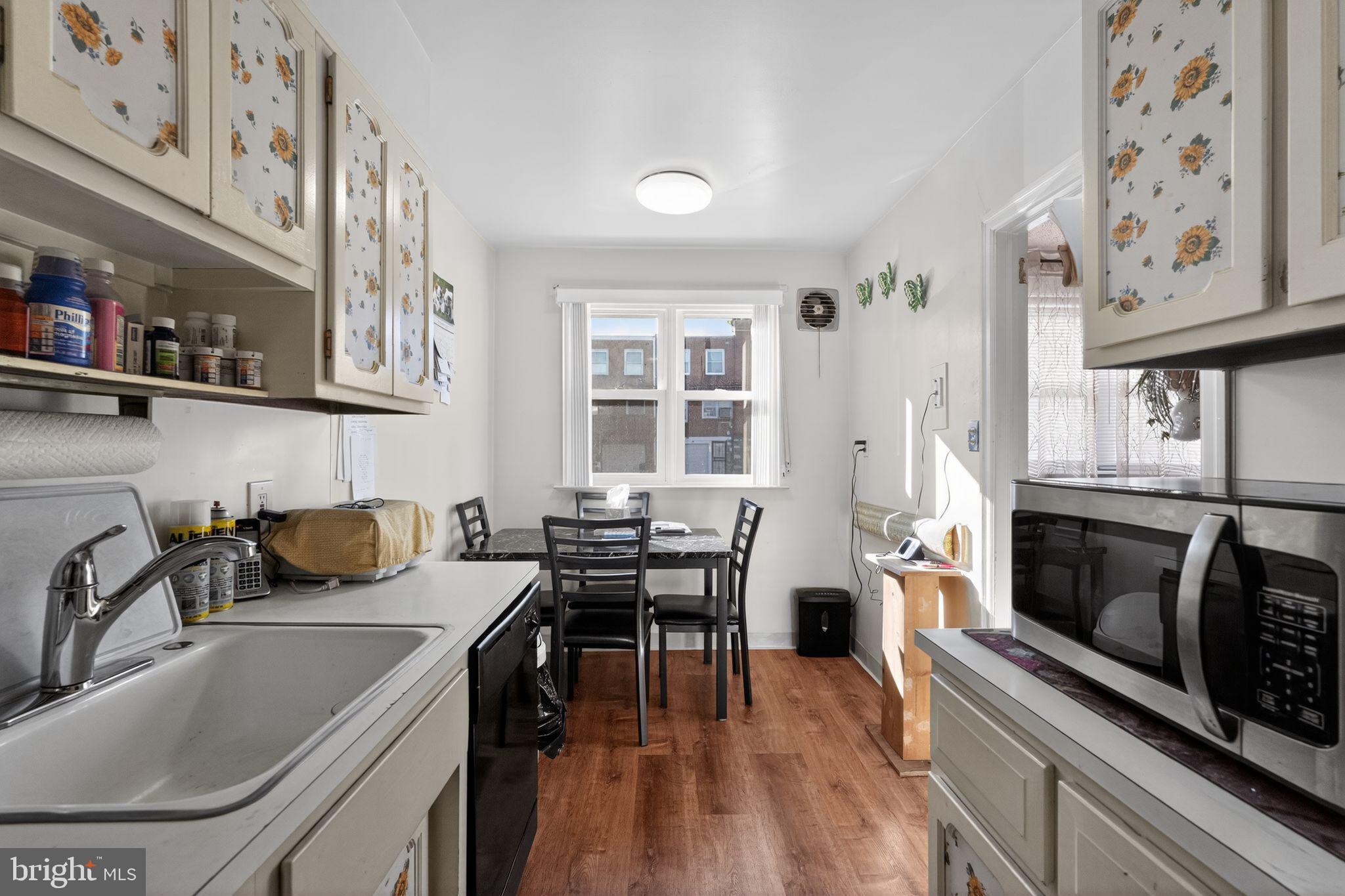 8238 Forrest Avenue Philadelphia, PA 19150 - Photo 12 of 29 a kitchen with stainless steel appliances granite countertop a stove a sink and a refrigerator
