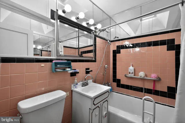 a bathroom with a sink a toilet and a mirror