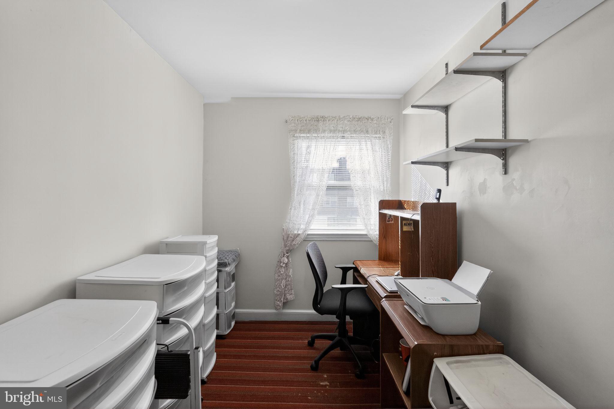 8238 Forrest Avenue Philadelphia, PA 19150 - Photo 22 of 29 a view of a workspace with furniture and wooden floor