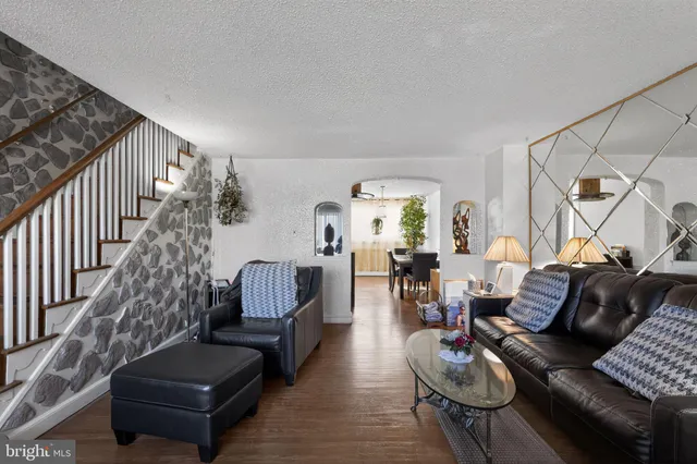 a living room with furniture or couch and a wooden floor