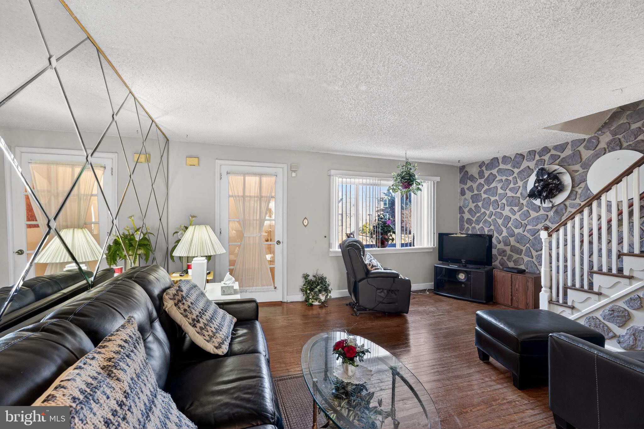 8238 Forrest Avenue Philadelphia, PA 19150 - Photo 7 of 29 a living room with furniture or couch and a flat screen tv