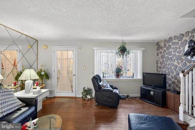 a living room with furniture fireplace and flat screen tv