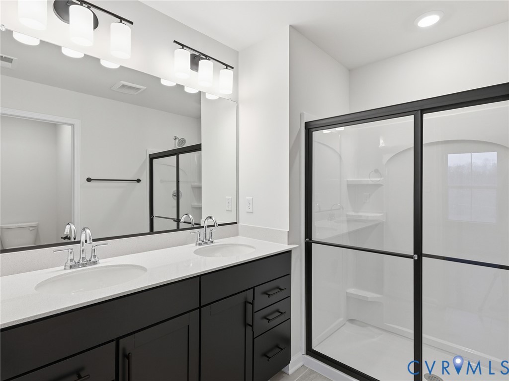161 Corcoran Way Aylett, VA 23009 - Photo 13 of 21 a bathroom with a double vanity sink mirror and double