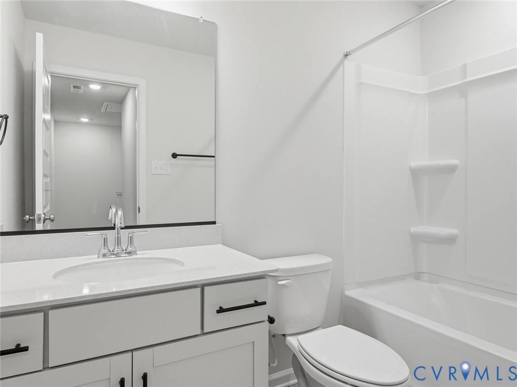 161 Corcoran Way Aylett, VA 23009 - Photo 16 of 21 a bathroom with a sink toilet vanity and tub