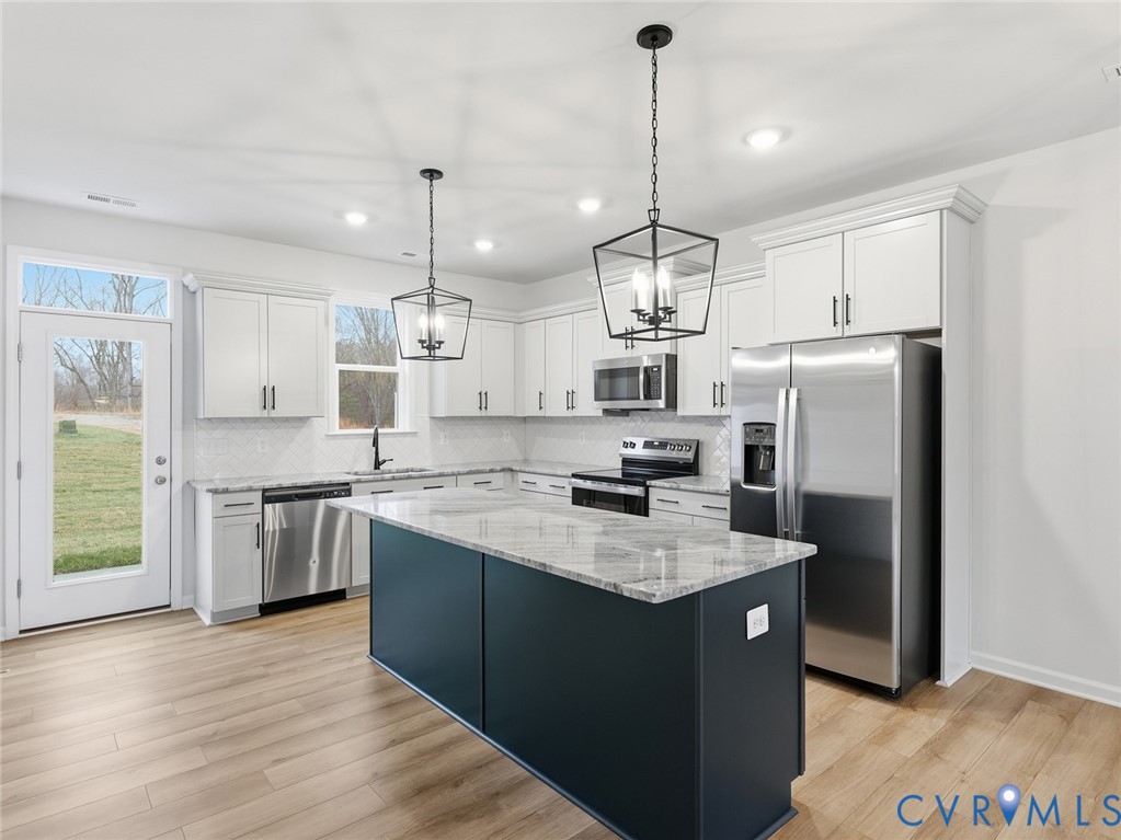 161 Corcoran Way Aylett, VA 23009 - Photo 2 of 21 a kitchen with stainless steel appliances granite countertop a sink a stove a refrigerator a center island a stove and a window