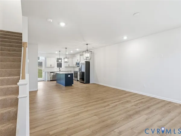a view of kitchen with kitchen island and stainless steel appliances