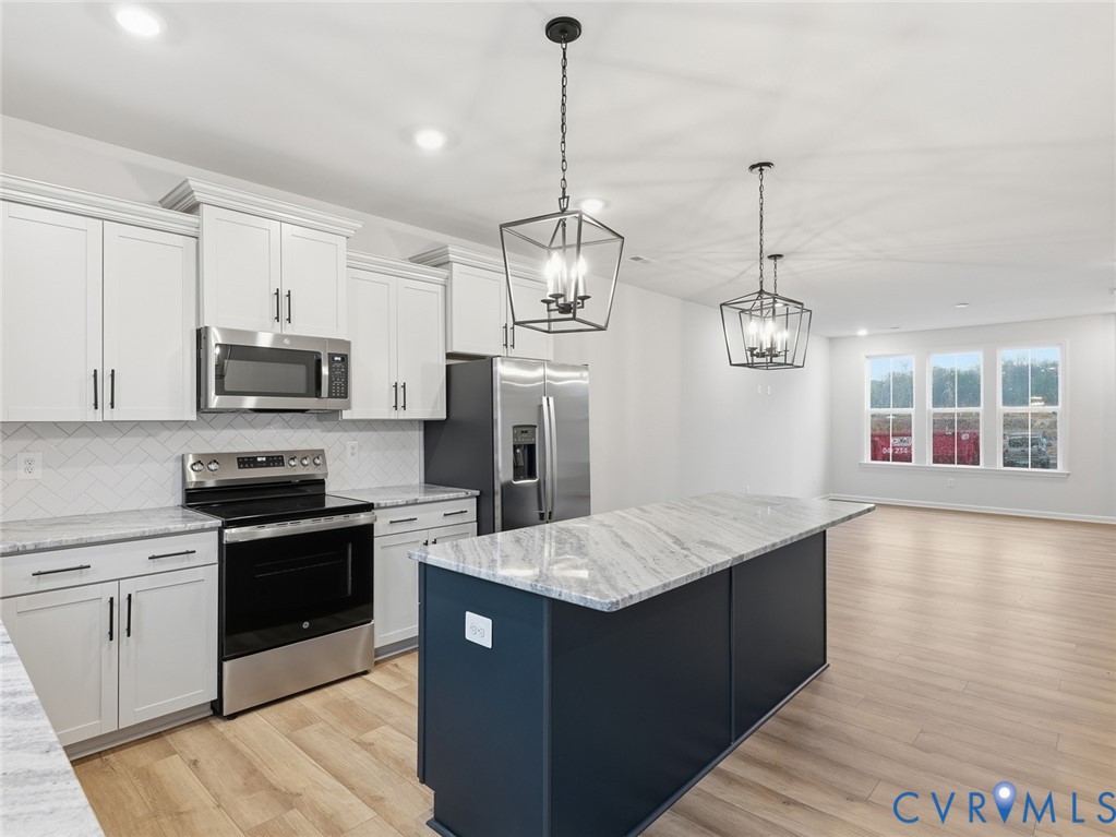 161 Corcoran Way Aylett, VA 23009 - Photo 4 of 21 a kitchen with stainless steel appliances granite countertop a sink stove and refrigerator