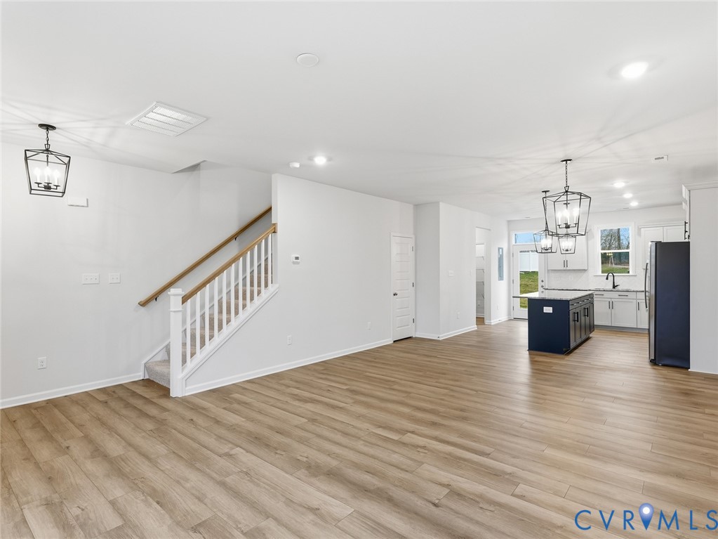161 Corcoran Way Aylett, VA 23009 - Photo 6 of 21 a open kitchen with white cabinets and wooden floor
