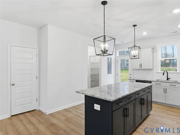 a kitchen with a counter top space and wooden floor