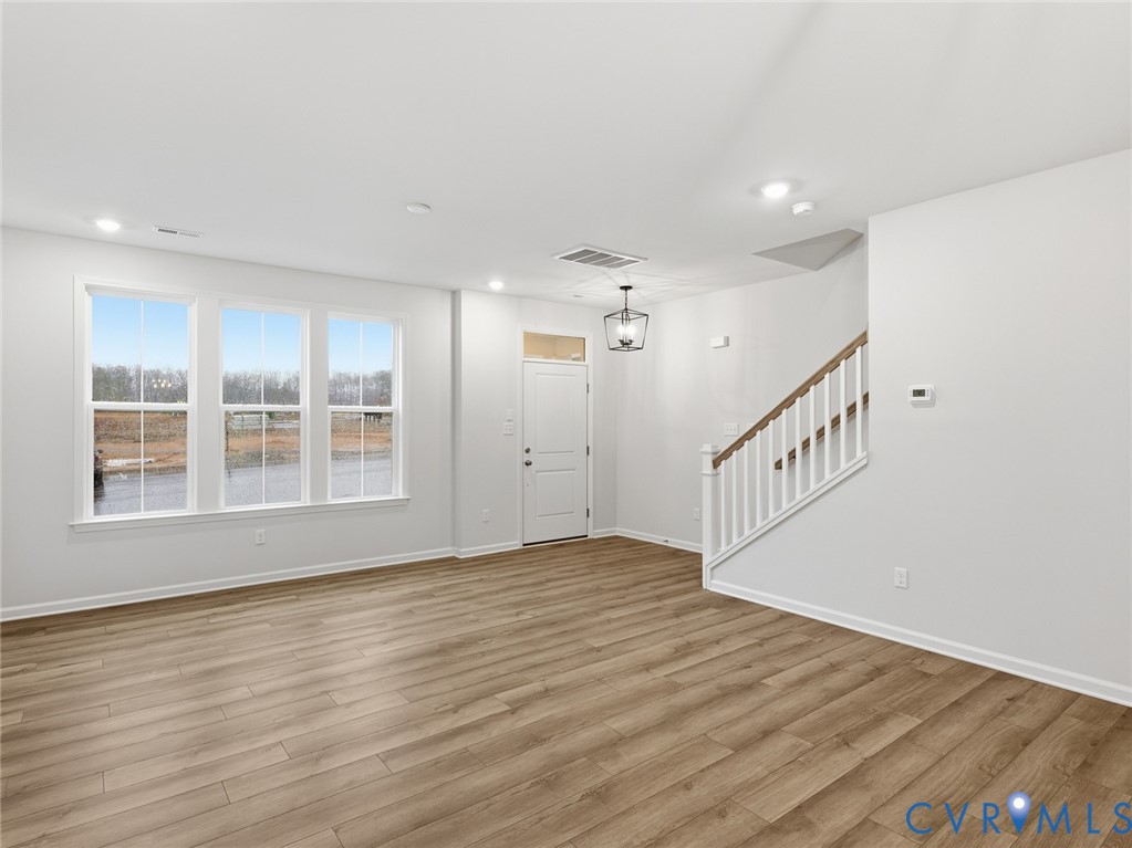 161 Corcoran Way Aylett, VA 23009 - Photo 9 of 21 a view of an empty room with wooden floor and a window