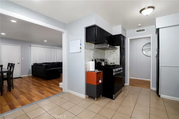 a kitchen with stainless steel appliances granite countertop a refrigerator and a stove